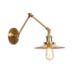 Elegant brass wall lamp with swivel arms and shade