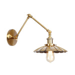 Elegant brass wall lamp with swivel arms and shade