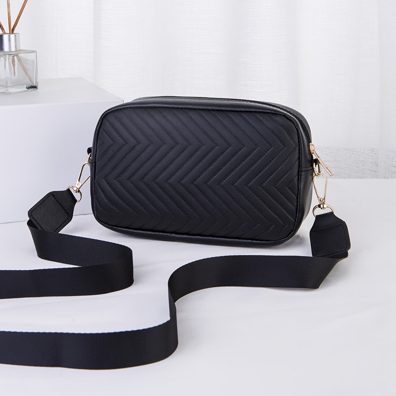 Black sequinned padded PU cross body bag with detachable strap