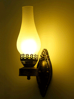 Antique iron wall lamp with glass shade in bronze