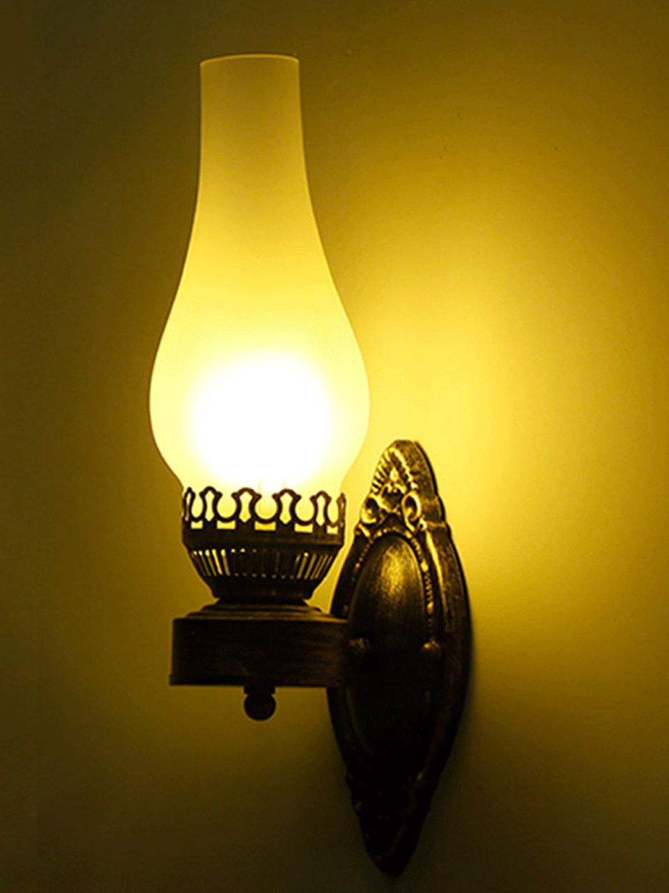 Antique iron wall lamp with glass shade in bronze