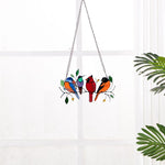Colorful stained-glass window hangings with bird motif