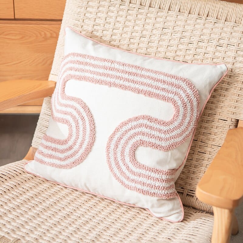 Schleifenförmiges, getuftetes Kissen in abstraktem Design