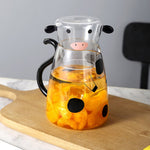 Glass pitcher with cow design and mug