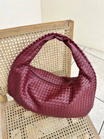 Elegant braided leather shoulder bag with secure zip closure