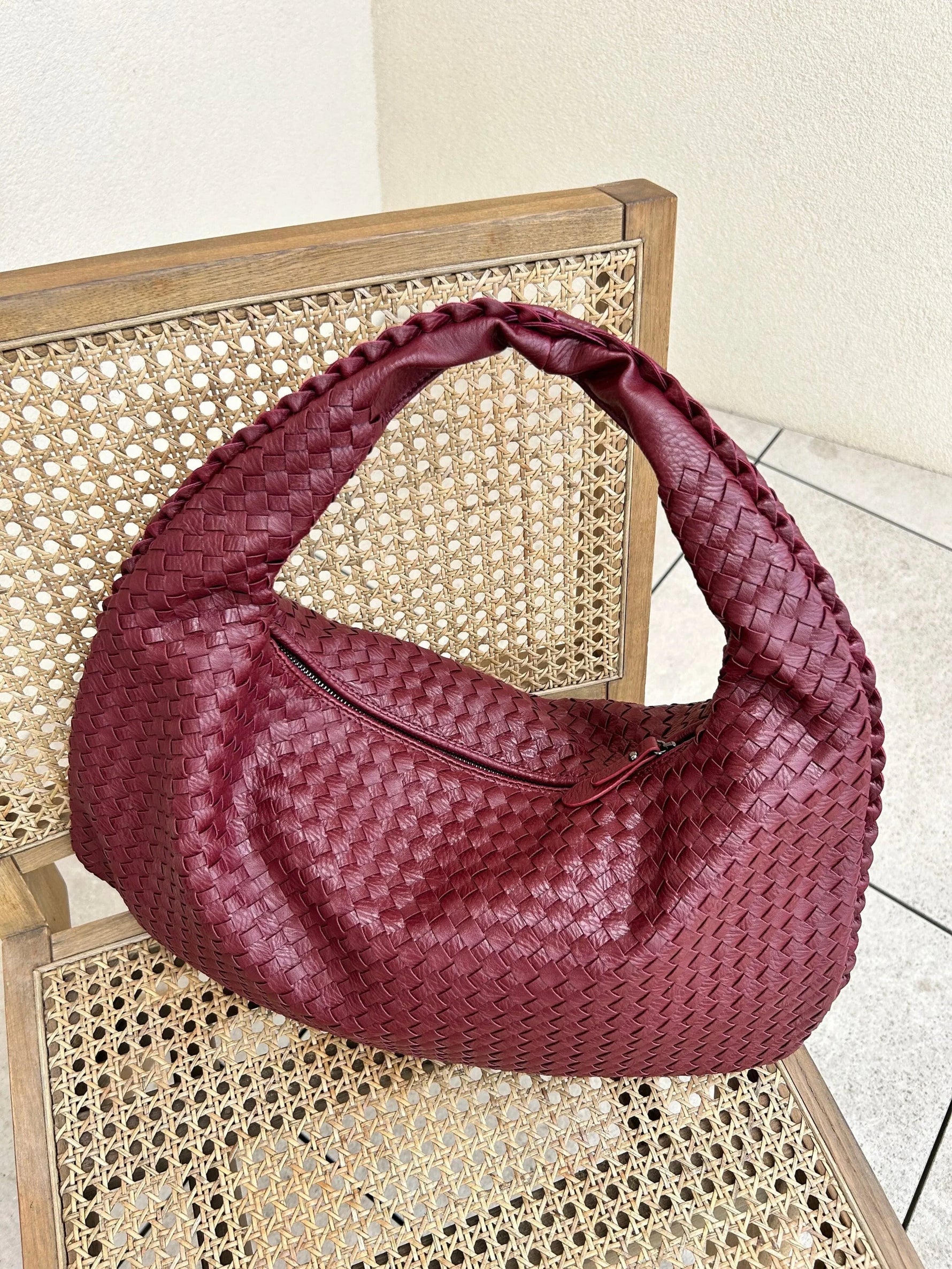 Elegant braided leather shoulder bag with secure zip closure