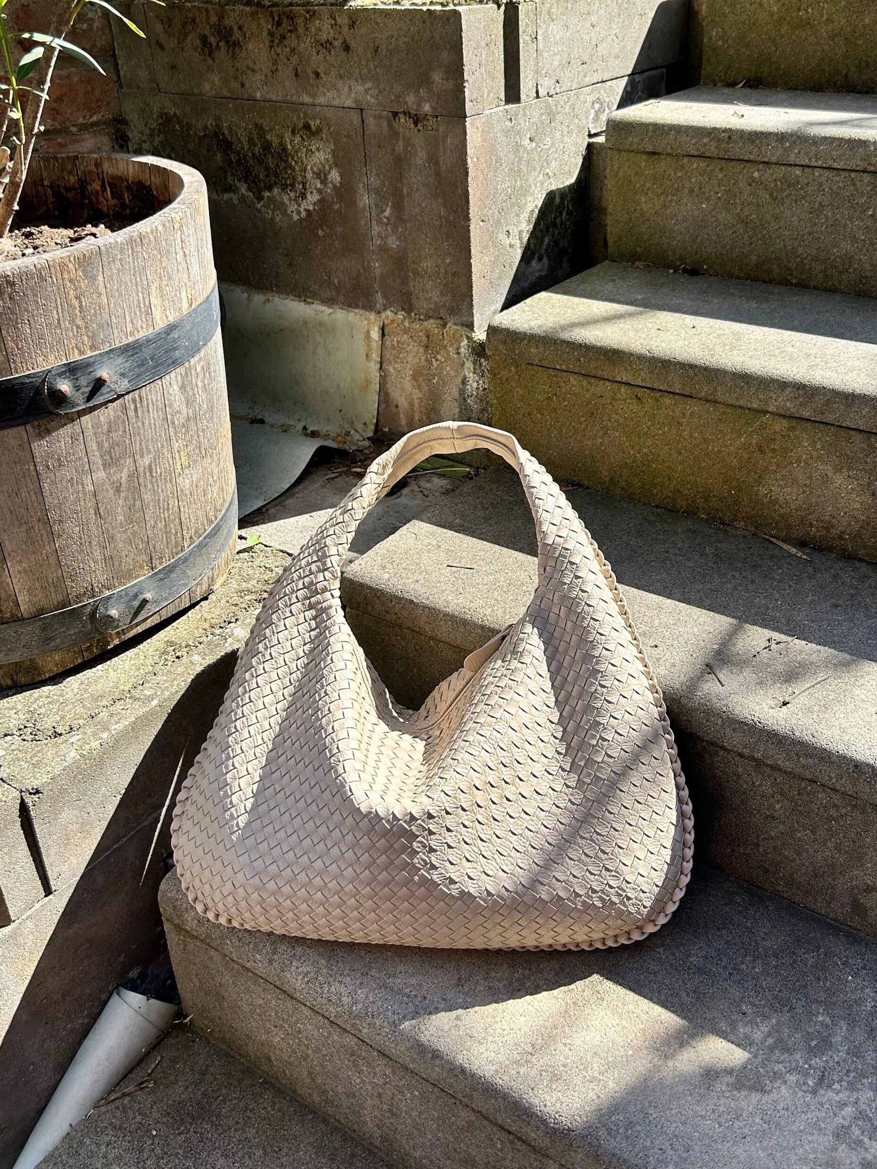 Elegant braided leather shoulder bag with secure zip closure