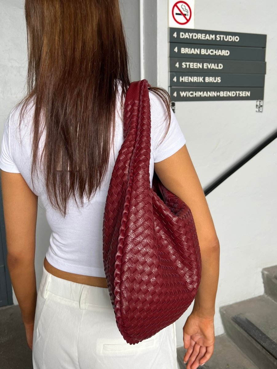 Elegant braided leather shoulder bag with secure zip closure