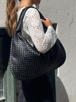 Elegant braided leather shoulder bag with secure zip closure