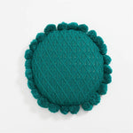 Round plush cushion with pompom and tassel in acrylic knit