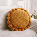 Round plush cushion with pompom and tassel in acrylic knit