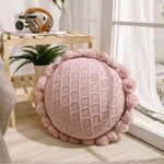 Round plush cushion with pompom and tassel in acrylic knit