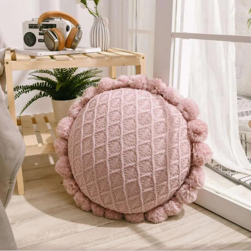 Round plush cushion with pompom and tassel in acrylic knit