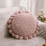 Round plush cushion with pompom and tassel in acrylic knit