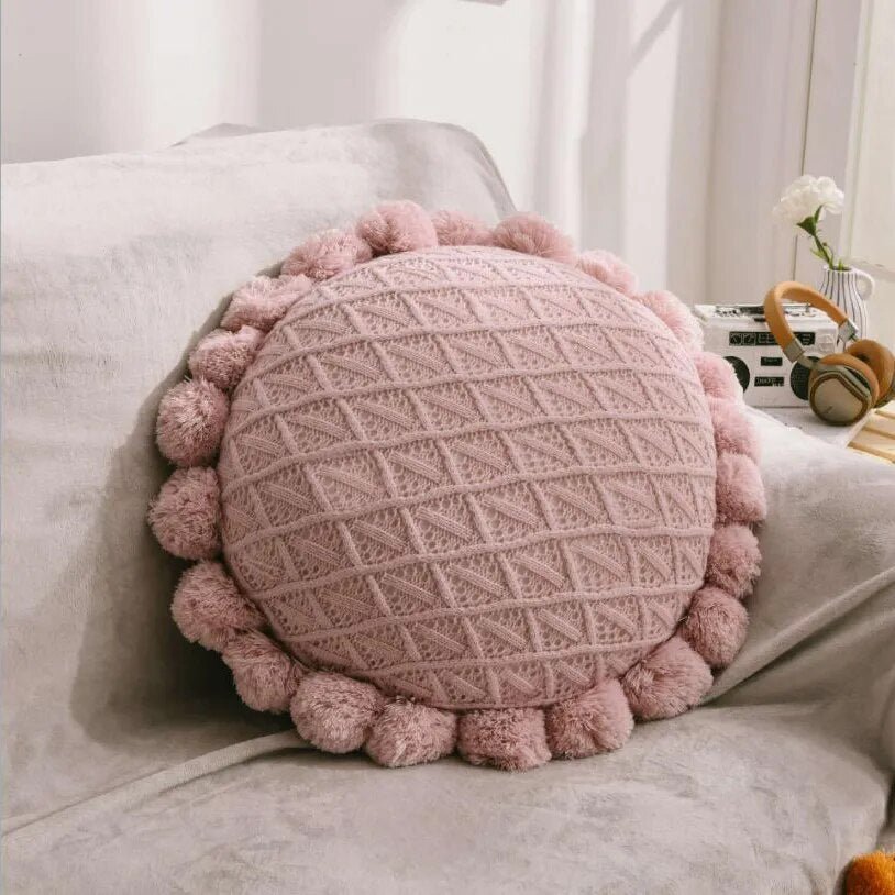 Round plush cushion with pompom and tassel in acrylic knit
