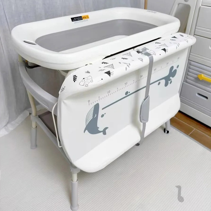 Compact changing table with height adjustment and integrated bath
