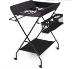 Compact changing table with height adjustment and integrated bath