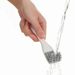 Grill cleaning brush with V-shaped head and scraper