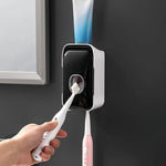 Wall-mounted toothpaste dispenser with adhesive installation