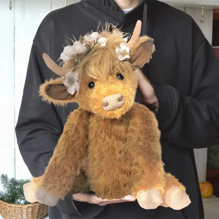 Hochlandrind mit Blumenkranz