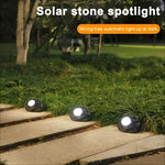 Solar-powered LED garden light in stone design with light sensor