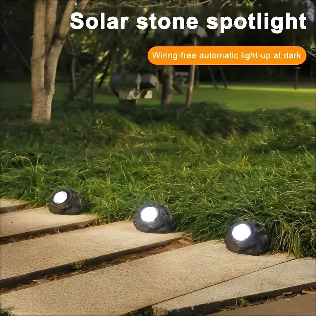 Solar-powered LED garden light in stone design with light sensor
