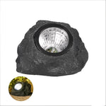 Solar-powered LED garden light in stone design with light sensor