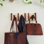 Elegant wooden wall coat rack with fold-out hooks