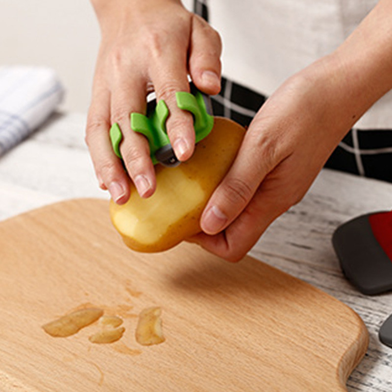Vegetable and fruit peeler with double finger grip